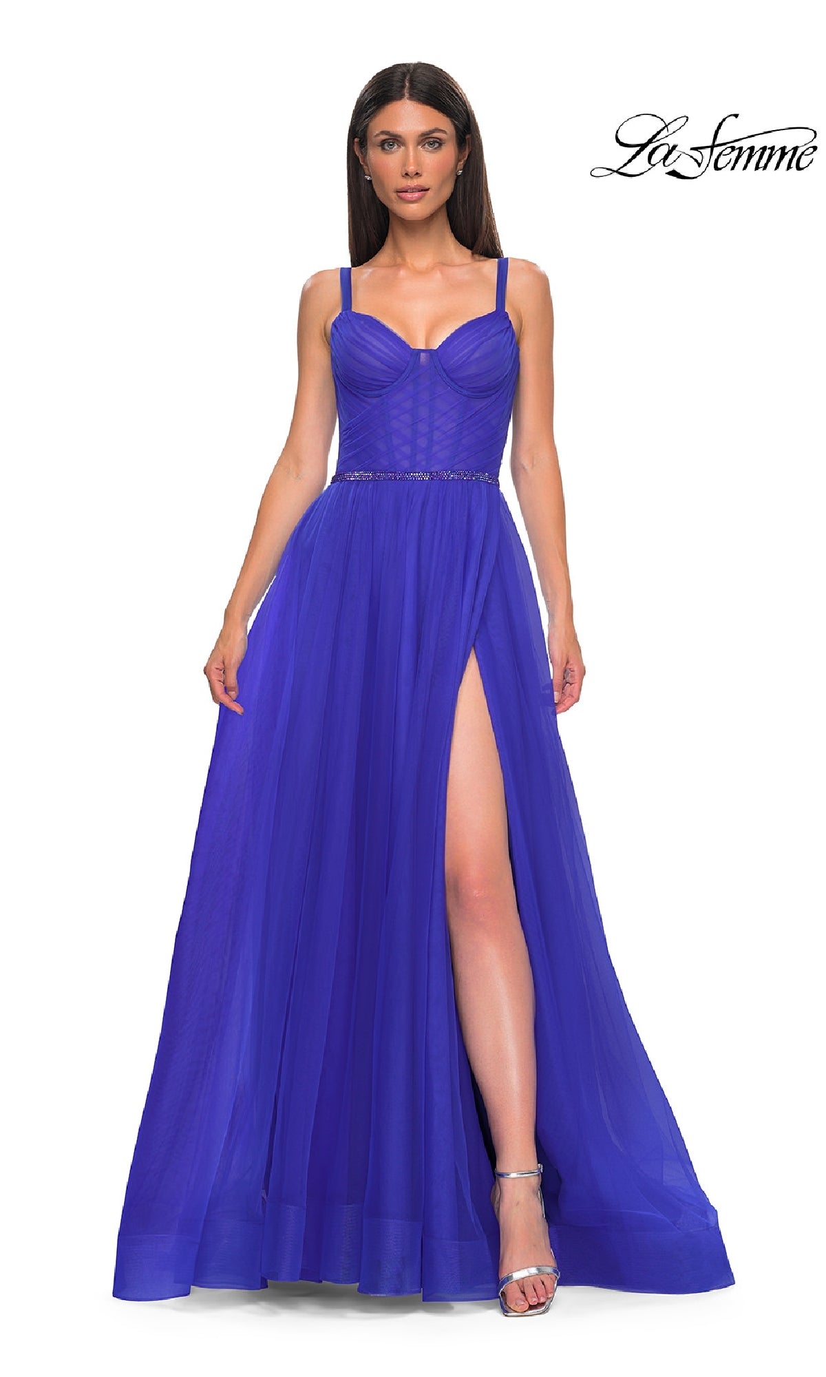 A woman poses standing in the La Femme 32956 Beaded-Waist Long Prom Ball Gown with a corset bodice and high slit, paired with silver high-heeled sandals. The La Femme logo appears in the top right corner.